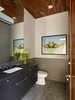 Modern home with Sliding Door Type, Metal, Exterior, Granite Counter, Undermount Sink, Limestone Floor, Ceiling Lighting, Ceramic Tile Wall, Two Piece Toilet, and Bath Room. Water closet Photo 7 of Modern Pool House