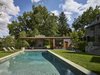 Modern home with Standard Layout Fireplace, Wood Burning Fireplace, Recliner, Limestone Floor, Back Yard, Trees, Shrubs, Table, Chair, and Outdoor. View from pool Photo 9 of Modern Pool House