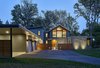 Modern home with Exterior, Flat RoofLine, Gable RoofLine, Glass Siding Material, Shed RoofLine, Wood Siding Material, Metal Roof Material, Stone Siding Material, and House Building Type. The home's main entry is accessed through a courtyard, and is marked by a prominent gabled roof form. Photo of Wallingford Passive Solar House
