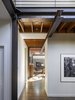 Modern home with Hallway and Medium Hardwood Floor. A dropped steel beam draws occupants into the main living area and defines a circulation corridor through the open spaces. Photo 4 of Wallingford Passive Solar House