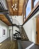 The entry foyer serves as a circulation hub, connecting the separate volumes of the home. Photo 14 of Wallingford Passive Solar House modern home