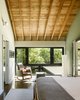 Modern home with Medium Hardwood Floor and Wall Lighting. Master bed and bath spaces orient towards the south-facing window wall, and receive plentiful natural light throughout the day. Photo 16 of Wallingford Passive Solar House