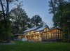 Modern home with Exterior, Gable RoofLine, Wood Siding Material, House Building Type, Glass Siding Material, Flat RoofLine, Butterfly RoofLine, Concrete Siding Material, Stone Siding Material, and Metal Roof Material. The home was positioned diagonally across the site, along a true east-west axis, allowing main living spaces and window walls to face due south. Photo 2 of Wallingford Passive Solar House