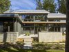 Modern home with Outdoor, Pavers Patio, Porch, Deck, Back Yard, Walkways, Grass, Hardscapes, Trees, Large Patio, Porch, Deck, Concrete Fences, Wall, and Stone Patio, Porch, Deck. Triple-pane fiberglass windows, continuous insulation, and careful air-sealing ensure that the envelope remains ultra-efficient, reducing demand on the HVAC system. Photo 8 of Wallingford Passive Solar House