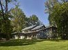 Modern home with Exterior, Flat RoofLine, Gable RoofLine, Stone Siding Material, Wood Siding Material, House Building Type, Metal Roof Material, Butterfly RoofLine, and Glass Siding Material. “Framed in exposed steel with expansive windows, the Wallingford Passive Solar House capitalizes on exterior views and shifting patterns of light to establish a dialogue with its surroundings, leading to a physical awareness of the sun’s movement throughout the day and the seasons,’ says Wyant Architecture. Photo 10 of Wallingford Passive Solar House