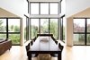The extensive use of wood on the interiors ties the house back to nature, as views of the ravine in the backyard can be enjoyed through the massive floor-to-ceiling windows along the kitchen and whole rear wall of the home. Photo 6 of Ravine House modern home