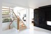 The staircase was relocated to enlarge the entrance foyer and improve the flow of space. Photo 9 of Ravine House modern home
