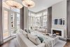 Modern home with Living Room, Sofa, Sectional, Ottomans, Coffee Tables, Chair, Ceiling Lighting, Medium Hardwood Floor, and Gas Burning Fireplace. Living Room Photo 3 of Battery Park City Residence