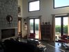 Modern home with Living Room, Bookcase, Concrete Floor, Ottomans, Sofa, Coffee Tables, Wood Burning Fireplace, and Floor Lighting. Living Room Photo 3 of Casa Sienna