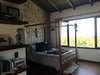 Modern home with Bedroom, Wall Lighting, Wardrobe, Chair, Bed, Medium Hardwood Floor, Shelves, Ceiling Lighting, and Bookcase. Master Bedroom Photo 7 of Casa Sienna
