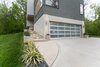 Exterior side shot showing concrete work and how the home is cut into the side of the hill. Photo 2 of The Sangar House modern home