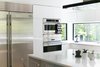 Daylight-filled kitchen with views of the trees and Geist Reservoir Photo 16 of The Sangar House modern home
