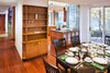 Modern home with Dining Room, Chair, Table, Bar, Storage, Shelves, Ceiling Lighting, Pendant Lighting, Medium Hardwood Floor, and Concrete Floor. Dining Photo 2 of Home for Sale: Takoma Park House