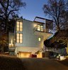 Modern home with Exterior, House Building Type, Tile Roof Material, Green Roof Material, Green Siding Material, and Flat RoofLine. Front house night view Photo 3 of Home for Sale: Takoma Park House
