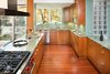 Modern home with Kitchen, Refrigerator, Cooktops, Range, Range Hood, Microwave, Dishwasher, Granite Counter, Wood Cabinet, Medium Hardwood Floor, Concrete Floor, Mosaic Tile Backsplashe, Undermount Sink, Pendant Lighting, and Ceiling Lighting. Kitchen Photo 6 of Home for Sale: Takoma Park House