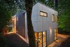 Modern home with Exterior, House Building Type, Green Roof Material, Concrete Siding Material, Green Siding Material, and Flat RoofLine. Rear house night view Photo 9 of Home for Sale: Takoma Park House