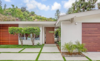 Front entry with peekaboo door and walnut slat screen.
Photo of Studio City MCM Sleeper modern home