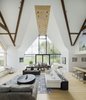 Modern home with Living Room, Coffee Tables, Bar, Bench, Lamps, Chair, Sofa, Ceiling Lighting, Stools, Table Lighting, Light Hardwood Floor, Console Tables, Table, and Rug Floor. Architect: Waind Gohil + Potter Architects
Photography: Anthony Coleman Photo 3 of The Old Barn Worton Farm