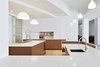 Modern home with Kitchen, Recessed Lighting, Engineered Quartz Counter, White Cabinet, Light Hardwood Floor, Ceiling Lighting, Pendant Lighting, Wood Cabinet, and Undermount Sink. Kitchen Photo of Tribeca Loft