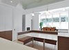 Modern home with Kitchen, Engineered Quartz Counter, Wood Cabinet, Ceiling Lighting, Pendant Lighting, Light Hardwood Floor, and White Cabinet. Kitchen, looking out past the dining room to the roof deck Photo 2 of Tribeca Loft