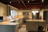 Modern home with Kitchen, Granite Counter, Track Lighting, Ceramic Tile Floor, Ceramic Tile Backsplashe, Wood Cabinet, Refrigerator, Dishwasher, Range Hood, Ceiling Lighting, and Range. Original timber roof, with modern LED track lighting. Photo 3 of Barn House
