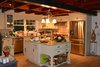 Modern home with Kitchen, Granite Counter, Wood Cabinet, Ceramic Tile Floor, Ceramic Tile Backsplashe, Ceiling Lighting, Recessed Lighting, and Refrigerator. Kitchen with ceramic wood look tile flooring. Photo 2 of Barn House