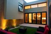 Modern home with Outdoor, Side Yard, Hardscapes, Grass, Small Patio, Porch, Deck, Concrete Patio, Porch, Deck, and Landscape Lighting. Interior Courtyard. Stained pine siding, and JamesHardie siding. View to kitchen. Photo 6 of The Huff Residence