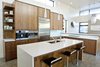 Modern home with Kitchen, Wood Cabinet, Glass Tile Backsplashe, Concrete Floor, Engineered Quartz Counter, Ceiling Lighting, Microwave, Cooktops, Refrigerator, Wall Oven, and Undermount Sink. Walnut Kitchen Cabinets by AvenueTwo, Caesarstone Countertops, Jenn-Air Appliances Photo 2 of The Huff Residence