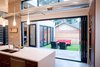 Modern home with Outdoor, Hardscapes, Side Yard, Small Patio, Porch, Deck, Concrete Patio, Porch, Deck, Horizontal Fences, Wall, and Landscape Lighting. Indoor Outdoor Kitchen with large bi-folding door Photo 3 of The Huff Residence