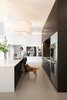 Modern home with Kitchen, Engineered Quartz Counter, Porcelain Tile Floor, Pendant Lighting, Wood Cabinet, Wall Oven, Refrigerator, and Undermount Sink. Kitchen Photo 9 of Donner Residence
