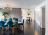 Modern home with Dining Room, Table, Chair, Pendant Lighting, and Dark Hardwood Floor. Dining area looking toward entry. Stone clad kitchen pantry wrap to right. Photo 3 of Donner Residence