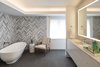 Modern home with Bath Room, Engineered Quartz Counter, Porcelain Tile Floor, Undermount Sink, Accent Lighting, Freestanding Tub, and Stone Tile Wall. Master Bathroom Suite Photo 6 of Donner Residence