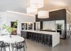 Modern home with Kitchen, Wood Cabinet, Porcelain Tile Floor, Stone Slab Backsplashe, Engineered Quartz Counter, Pendant Lighting, Refrigerator, Wall Oven, Cooktops, and Undermount Sink. Kitchen and Dining Area Photo 5 of Donner Residence