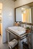 Modern home with Bath Room, Wood Counter, Vessel Sink, Subway Tile Wall, and Concrete Floor. Bathroom Vanity. Salvaged from Blacksmith workshop bench. Original window frame used for mirror. Subway tile interior. Photo 10 of Blacksmith Shop