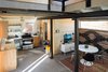 Modern home with Living Room, Ceiling Lighting, Chair, and Concrete Floor. Living and Kitchen Area from Staircase Photo 13 of Blacksmith Shop
