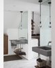 Modern home with Bath Room, Concrete Counter, Porcelain Tile Floor, Wall Mount Sink, Freestanding Tub, Open Shower, Pendant Lighting, and Ceramic Tile Wall. Master Bathroom. Floating concrete sinks, with floating walnut shelves below. Master closet beyond. Photo 11 of Thole Residence