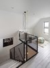 Modern home with Staircase, Wood Tread, and Metal Railing. Staircase with custom metal railing. Pendant lights by Color Cord Company. Prefinished white oak flooring. Photo 9 of Thole Residence