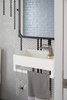 Modern home with Bath Room, Ceramic Tile Floor, Wall Mount Sink, and Ceramic Tile Wall. Powder room vanity detail. Photo 7 of Thole Residence