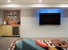 Modern home with Living Room, Sectional, and Ceiling Lighting. Media room with custom made brass wrap bar area by Platform Workshop. Photo 16 of Forest Residence