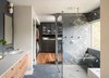 Modern home with Bath Room, Engineered Quartz Counter, Porcelain Tile Floor, Undermount Sink, and Ceiling Lighting. Master Bathroom with heath ceramics throughout. Custom vanity by Platform Workshop. Closet by Closet Factory. Photo 14 of Forest Residence