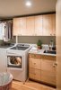 Modern home with Engineered Quartz Counter and Wood Cabinet. Laundry room with custom cabinets by Platform Workshop. Photo 11 of Forest Residence