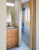 Modern home with Bath Room, Engineered Quartz Counter, Ceramic Tile Floor, Undermount Sink, and Wall Lighting. Guest Bathrooms. Custom hickory vanity cabinets and 3 color tile motif from Daltile. Photo 18 of Forest Residence