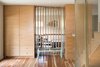 Modern home with Staircase, Wood Tread, and Metal Railing. Entry way with custom made entry closet built-in, hickory fins, and custom wall wraps by Platform Workshop. Perforated metal screens by Gulley Metal. Photo 2 of Forest Residence