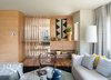 Modern home with Living Room, Chair, Ceiling Lighting, Floor Lighting, Sofa, Coffee Tables, Ottomans, and Medium Hardwood Floor. Living room looking toward entry and sitting area. All custom hickory built-ins by Platform Workshop. Photo 6 of Forest Residence