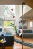 Modern home with Living Room, Sofa, End Tables, Pendant Lighting, and Medium Hardwood Floor. Sitting area looking out to front of house. All furniture from Room & Board. Perforated metal screen by Gulley Metal. Photo 7 of Forest Residence