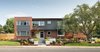 Modern home with Exterior, House Building Type, Metal Roof Material, and Brick Siding Material. Exterior of home. Matching brick to the original was found to extend up to the second floor. Front trellis disguises the new addition. Rooftop deck hidden behind the trees. Photo of Forest Residence