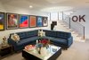 Modern home with Living Room, Sectional, Coffee Tables, Ceiling Lighting, and Rug Floor. Media room that was added below the new garage. Has an additional guest suite on the lower level as well. Photo 8 of Richthofen Residence