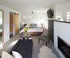 Modern home with Bedroom, Bed, Dresser, Night Stands, Ceiling Lighting, and Carpet Floor. Master Suite with original fireplace from the 1950's addition. Photo 6 of Richthofen Residence