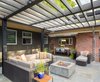 Modern home with Outdoor, Back Yard, Shrubs, Grass, Stone Patio, Porch, Deck, Horizontal Fences, Wall, and Concrete Patio, Porch, Deck. Outdoor patio area looking back toward covered dining and kitchen. Original brick exterior was restored and maintained. Photo 15 of Richthofen Residence