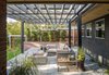 Modern home with Outdoor, Back Yard, Trees, Shrubs, Concrete Patio, Porch, Deck, Stone Patio, Porch, Deck, Horizontal Fences, Wall, and Landscape Lighting. New outdoor patio area to backyard off covered dining area. Photo 14 of Richthofen Residence